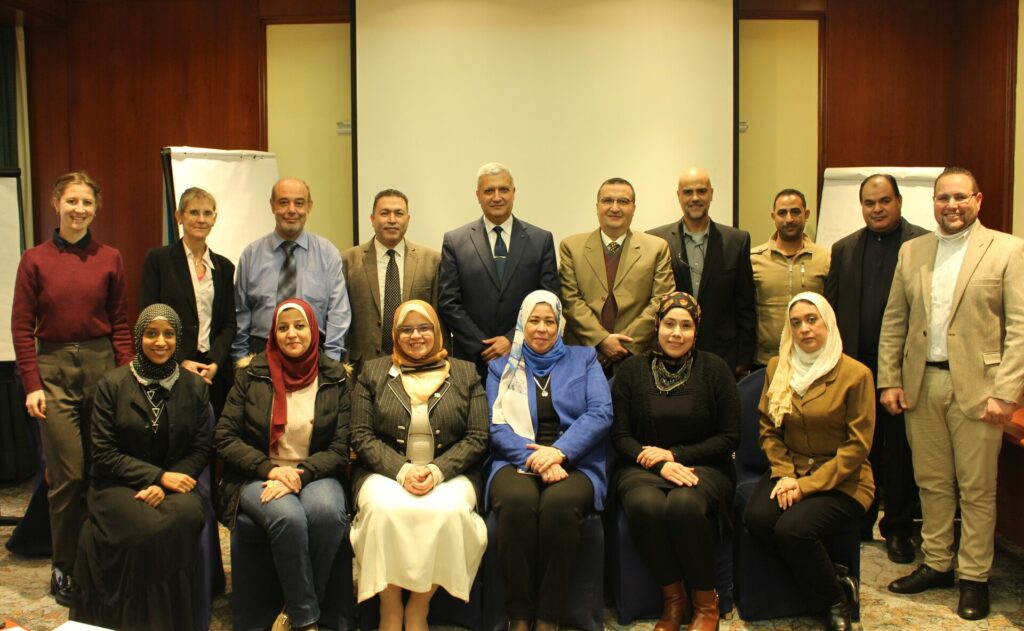 Group of 16 participants sitting and standing in two rows