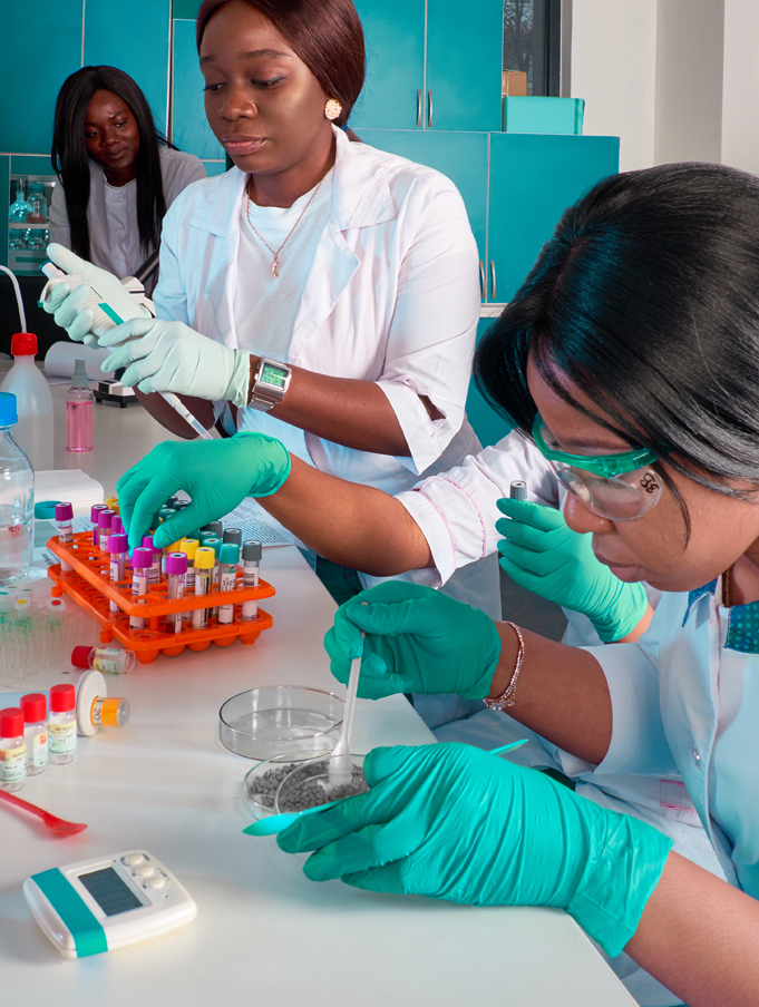 Four African women doctors in front of a laboratory bench analysing Covid-19 test samples