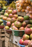 A stand consisting of wooden crates with bowls full of fruit.