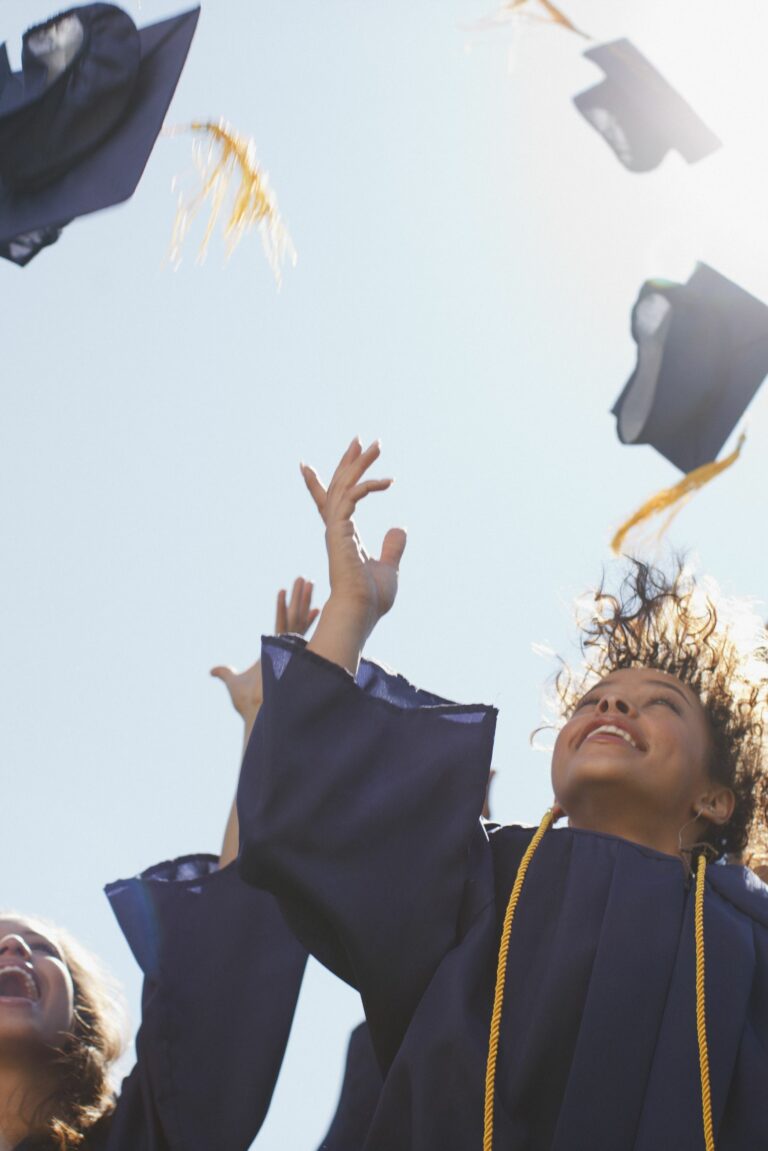 Graduates tossing caps into the air.