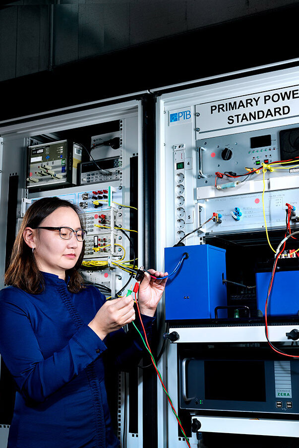 Woman in the laboratory in front of PTB's Primary Power Standard