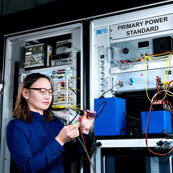 Woman in the laboratory in front of PTB's Primary Power Standard