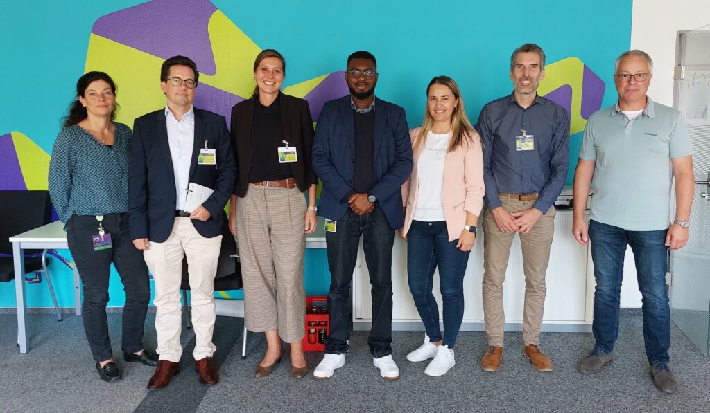 A group of people in front of a wall.