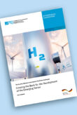 H2 is written on a metal pole. Wind turbines and solar panels can be seen in the background.