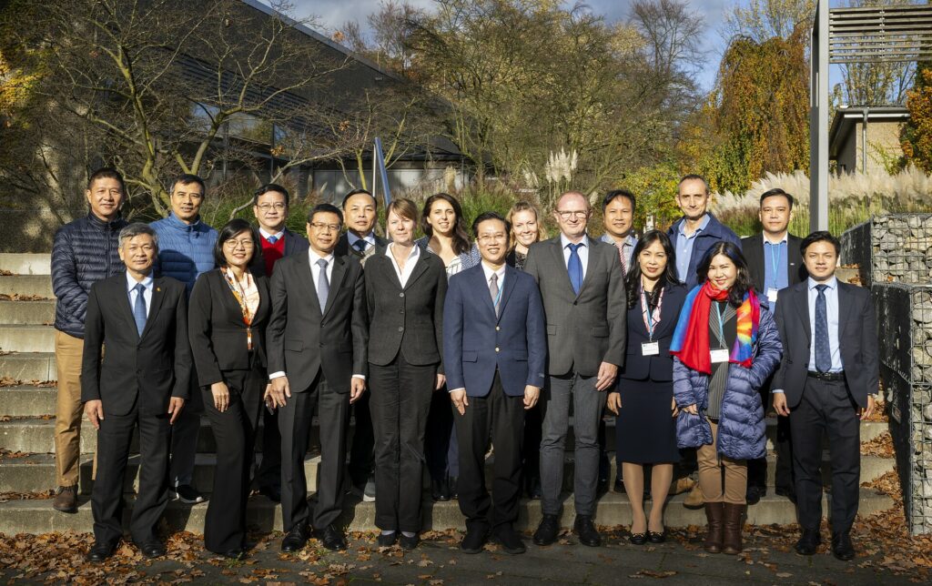 A group of people are standing in two rows and posing for a group picture.