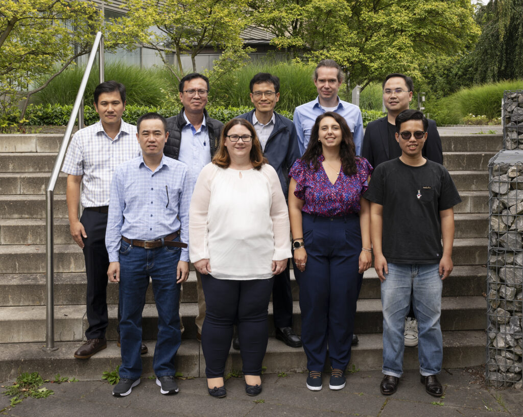 A group of delegates standing on an outdoor staircase at PTB.