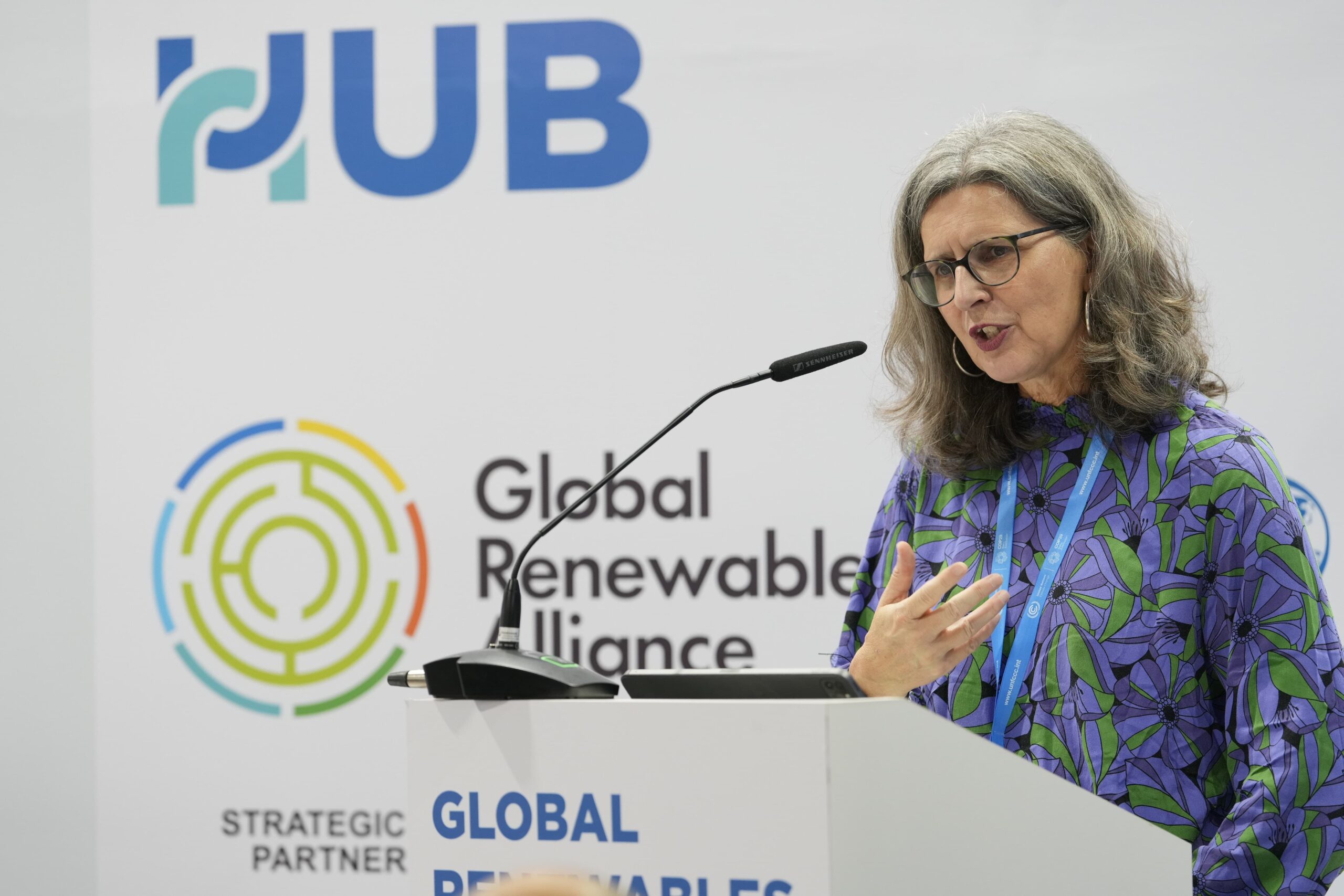 A woman standing at a lectern and giving a speech.