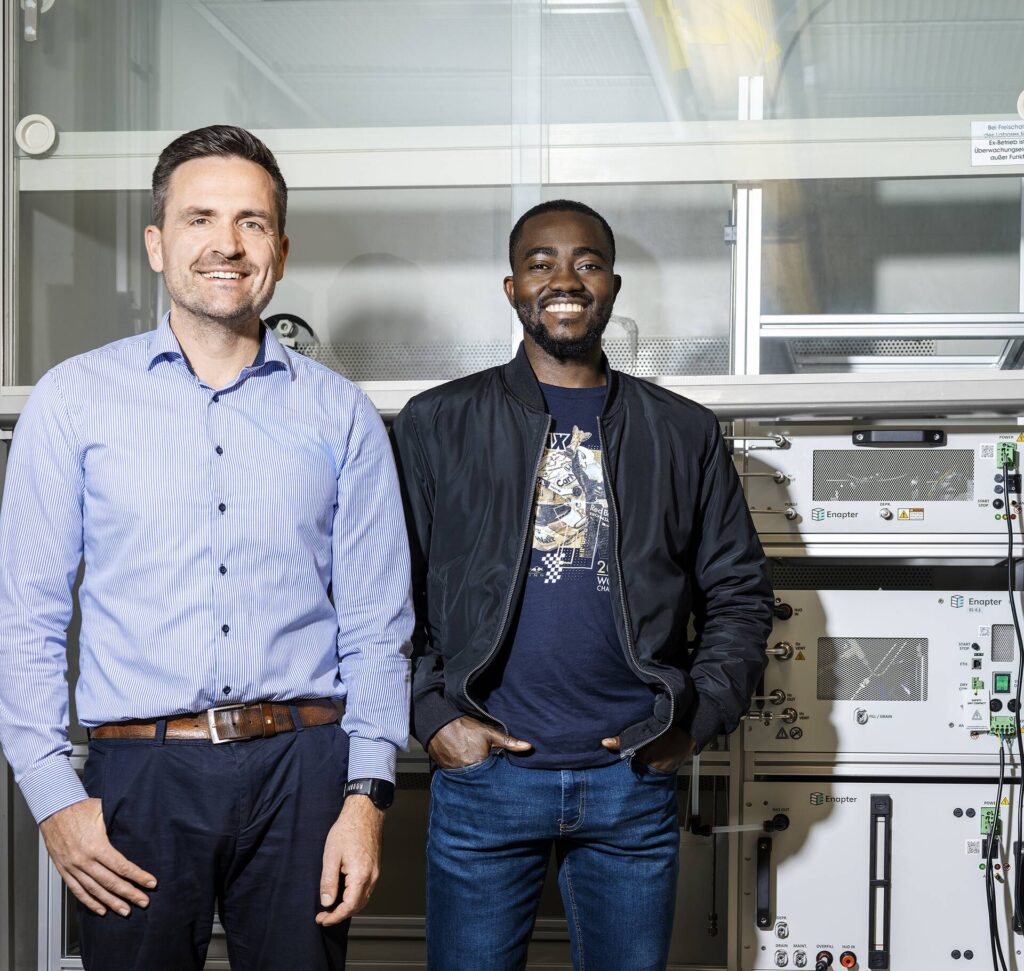 Two men are standing in a laboratory