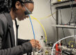 A woman working with high-tech equipment in a modern lab