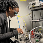 A woman working with high-tech equipment in a modern lab