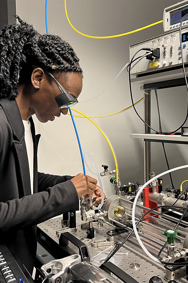 A woman working with high-tech equipment in a modern lab