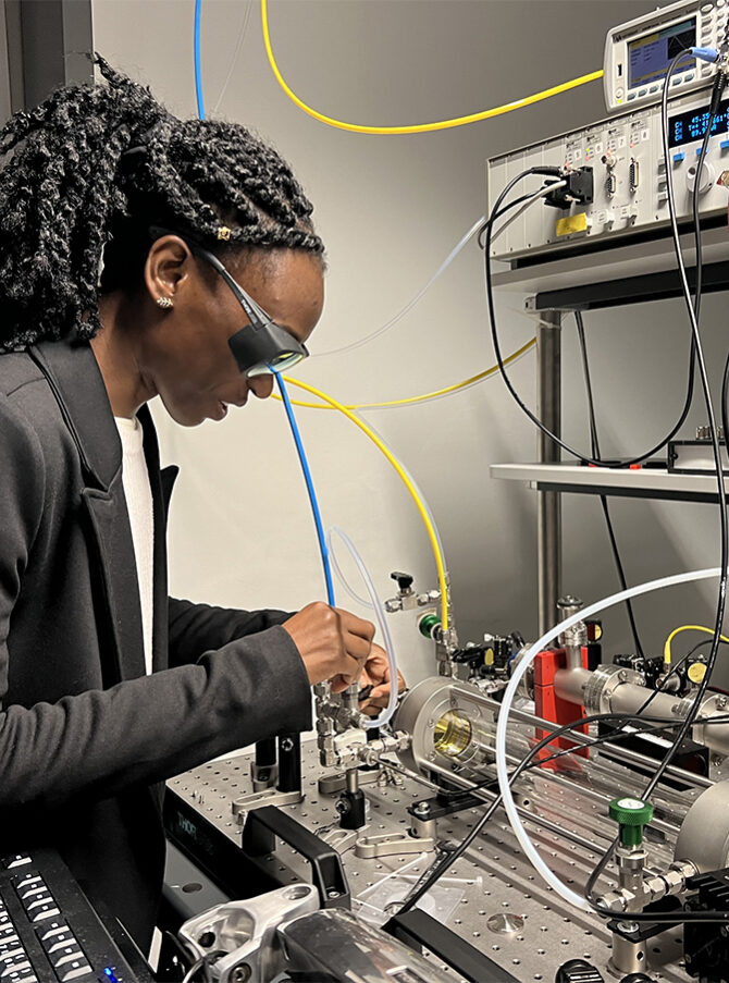 A woman working with high-tech equipment in a modern lab