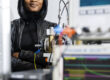 A woman is standing in a laboratory
