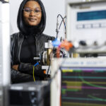 A woman is standing in a laboratory