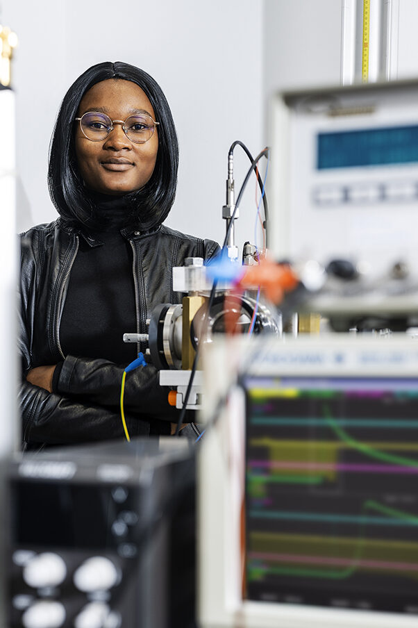 A woman is standing in a laboratory