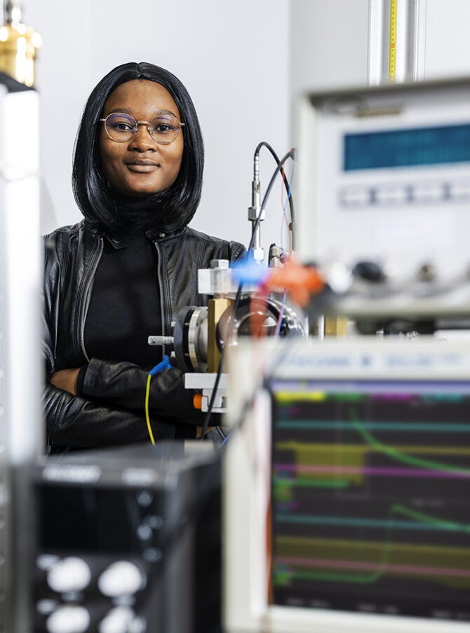 A woman is standing in a laboratory