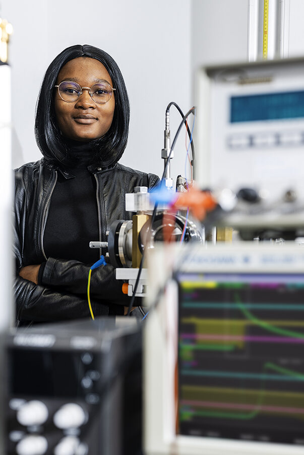 A woman is standing in a laboratory
