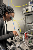 A woman working with high-tech equipment in a modern lab