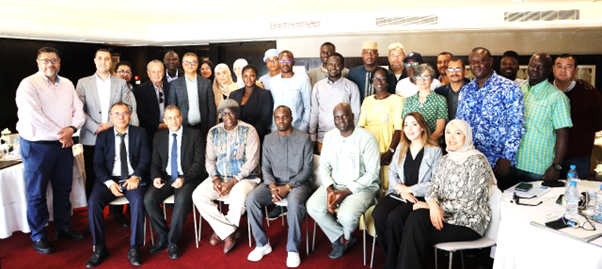 Plusieurs personnes sont assises et se tiennent en rang pour une photo de groupe.