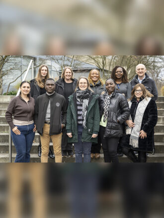 A group photo of the members of the QuISP Alumni Network Team standing outside on some steps at PTB Braunschweig