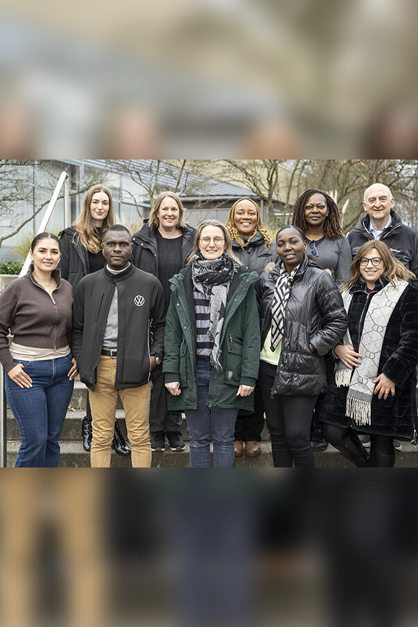 A group photo of the members of the QuISP Alumni Network Team standing outside on some steps at PTB Braunschweig