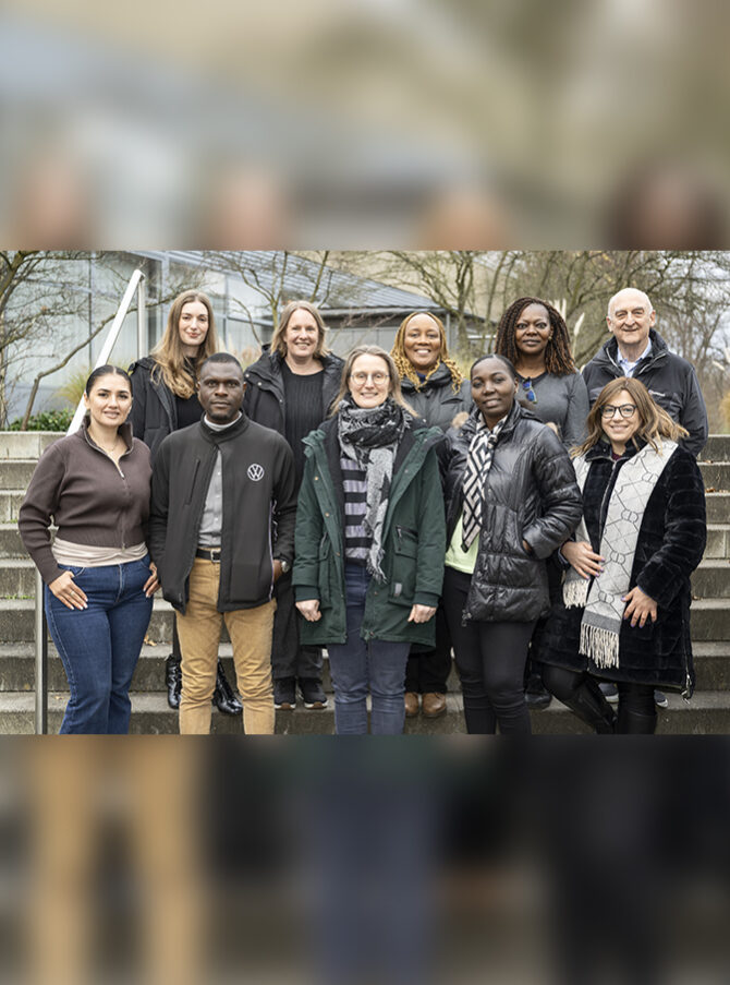 A group photo of the members of the QuISP Alumni Network Team standing outside on some steps at PTB Braunschweig