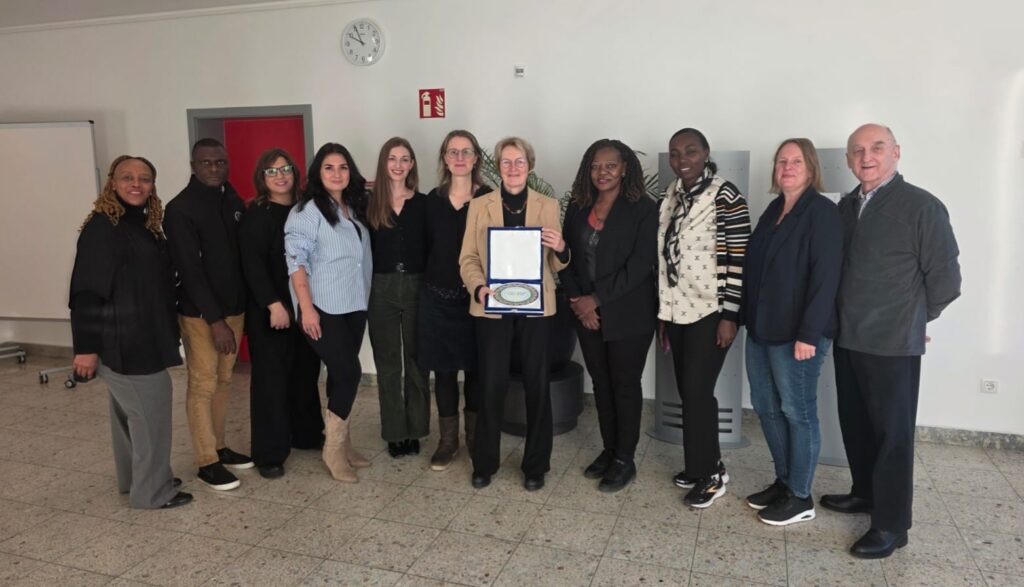 Members of the QuISP Alumni Network Team with the Head of PTB’s International Cooperation Group, Dr. Marion Stoldt, who is pleased to be holding a QuISP Alumni Network plate that was gifted to PTB by the network moderators. The traditional Tajik plate has the QuISP Alumni Network logo on it.